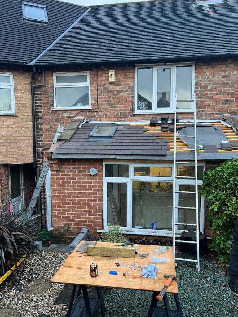 This is a photo of a roof extension that is having new roof tiles installed. This is a photo taken from the roof ridge looking down a tiled pitched roof on to a flat roof. Works carried out by Dartford Roofing Repairs